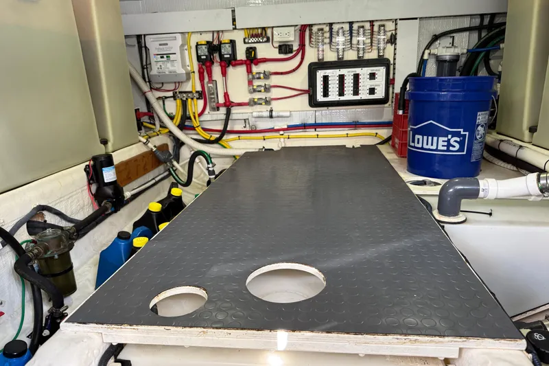 Slide: The Image of Engine room of 2017 Sabre 38 Salon Express with wiring, pipes, and maintenance supplies. - 80