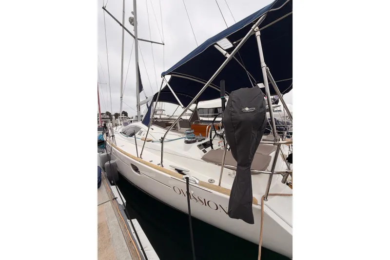 Slide: The Image of 2014 Jeanneau Sun Odyssey 50 DS sailboat docked, featuring sleek design and covered equipment. - 11