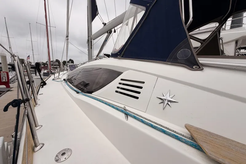 Slide: The Image of 2014 Jeanneau Sun Odyssey 50 DS sailboat docked, showcasing sleek design and nautical details. - 12