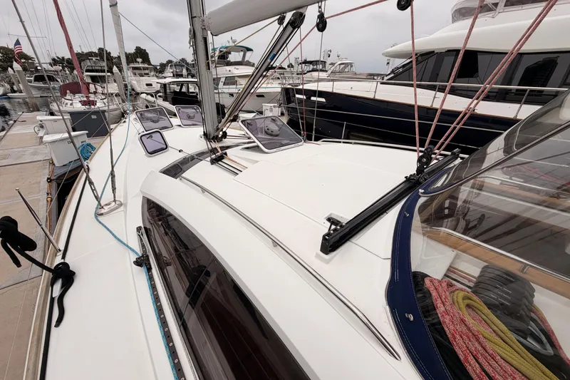 Slide: The Image of 2014 Jeanneau Sun Odyssey 50 DS sailboat docked at marina, showcasing deck and rigging. - 13