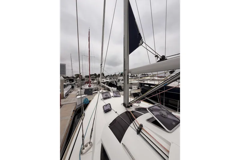 Slide: The Image of 2014 Jeanneau Sun Odyssey 50 DS sailboat docked at marina under cloudy sky. - 14
