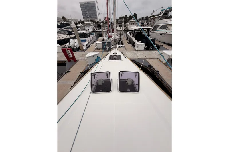 Slide: The Image of Jeanneau Sun Odyssey 50 DS 2014 yacht docked at marina, showcasing sleek deck design. - 15