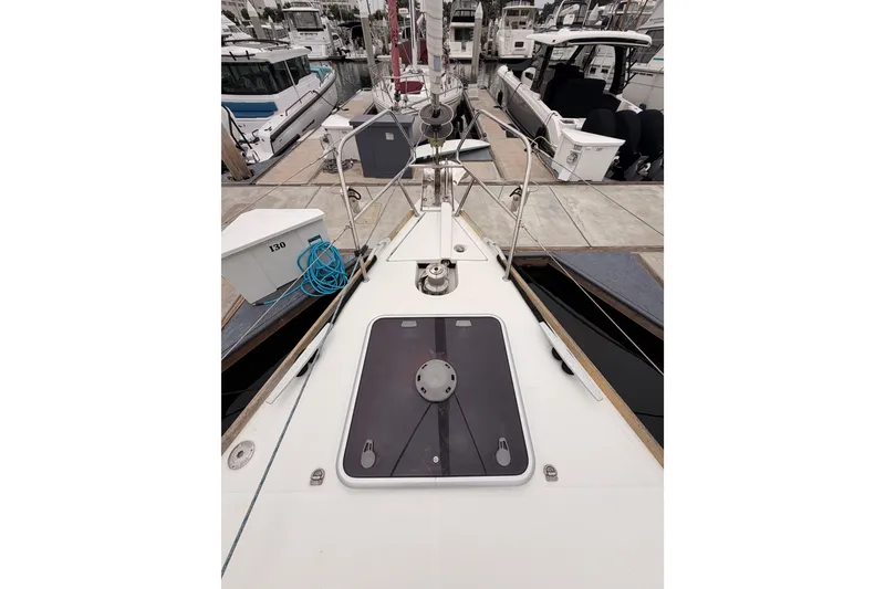 Slide: The Image of 2014 Jeanneau Sun Odyssey 50 DS yacht docked at marina, showcasing deck and hatch. - 16