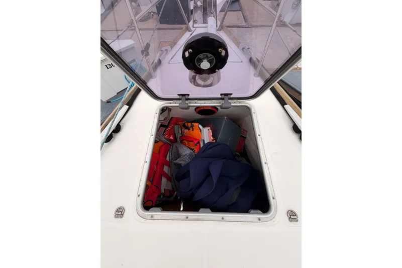 Slide: The Image of Open hatch on Jeanneau Sun Odyssey 50 DS sailboat, revealing storage compartment with gear. - 17