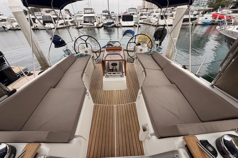 Slide: The Image of 2014 Jeanneau Sun Odyssey 50 DS yacht cockpit with dual steering wheels and cushioned seating. - 25
