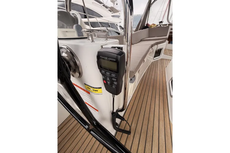 Slide: The Image of 2014 Jeanneau Sun Odyssey 50 DS cockpit with radio and teak flooring. - 33