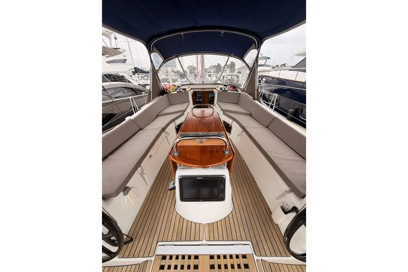 Slide: The Image of Cockpit of 2014 Jeanneau Sun Odyssey 50 DS sailboat with teak flooring and cushioned seating. - 36