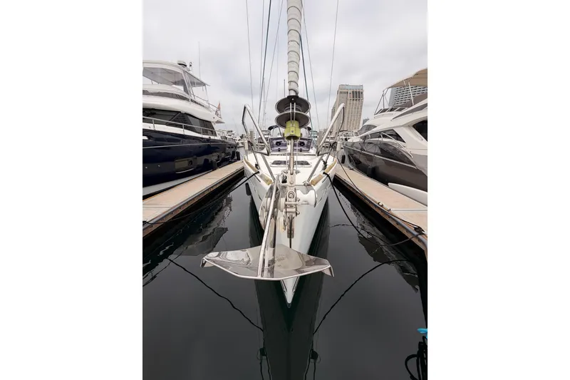 Slide: The Image of 2014 Jeanneau Sun Odyssey 50 DS yacht docked between two boats. - 4