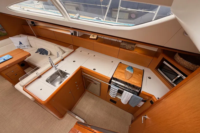 Slide: The Image of Luxurious interior of 2014 Jeanneau Sun Odyssey 50 DS yacht, featuring modern kitchen and seating area. - 40