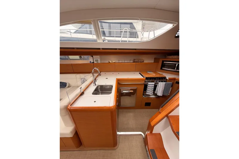 Slide: The Image of Interior of 2014 Jeanneau Sun Odyssey 50 DS yacht, featuring a modern kitchen galley. - 43