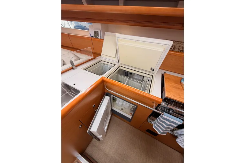 Slide: The Image of Modern kitchen in 2014 Jeanneau Sun Odyssey 50 DS yacht with open fridge and stove. - 45