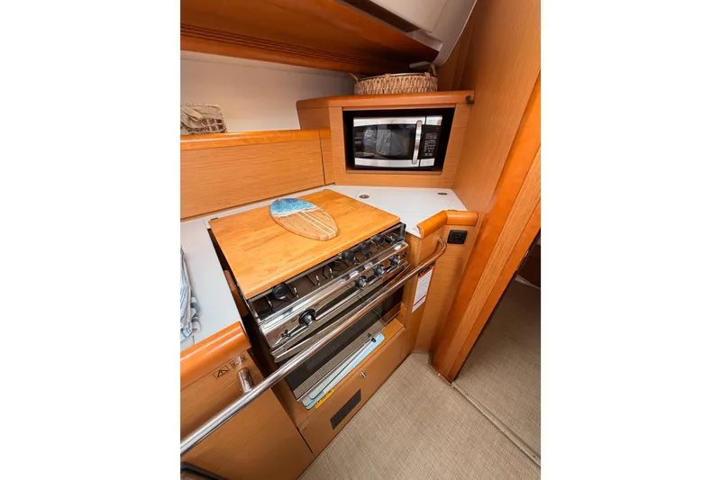 Slide: The Image of Galley kitchen in 2014 Jeanneau Sun Odyssey 50 DS yacht with stove and microwave. - 46