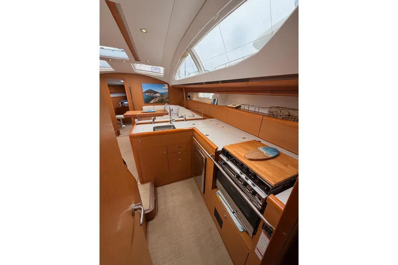 Slide: The Image of Interior of 2014 Jeanneau Sun Odyssey 50 DS yacht, featuring a modern kitchen galley. - 48