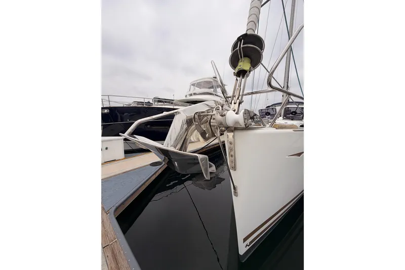 Slide: The Image of 2014 Jeanneau Sun Odyssey 50 DS sailboat docked at marina, showcasing bow and anchor. - 5