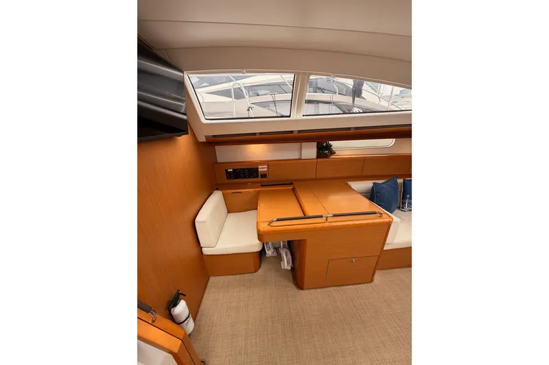 Slide: The Image of Interior of 2014 Jeanneau Sun Odyssey 50 DS yacht with wooden furnishings and seating area. - 50