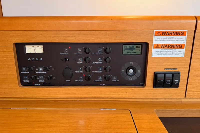 Slide: The Image of Control panel of a 2014 Jeanneau Sun Odyssey 50 DS sailboat with warning labels. - 51