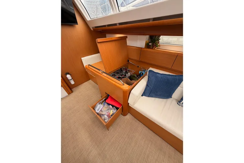 Slide: The Image of Interior of 2014 Jeanneau Sun Odyssey 50 DS with storage and seating area. - 54
