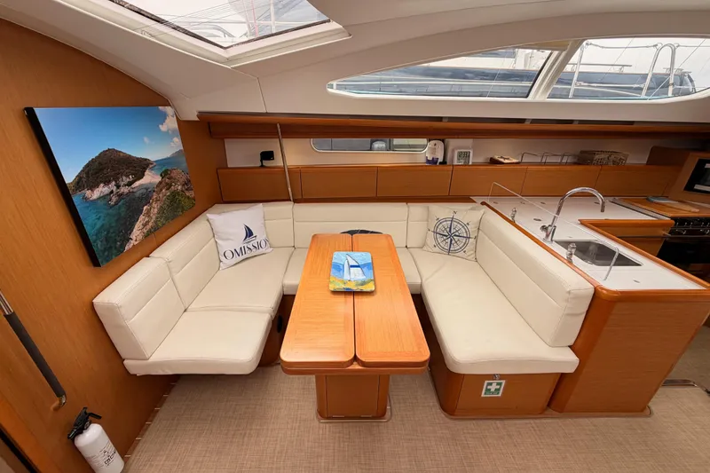 Slide: The Image of Luxurious interior of 2014 Jeanneau Sun Odyssey 50 DS yacht with elegant seating and modern kitchen. - 55