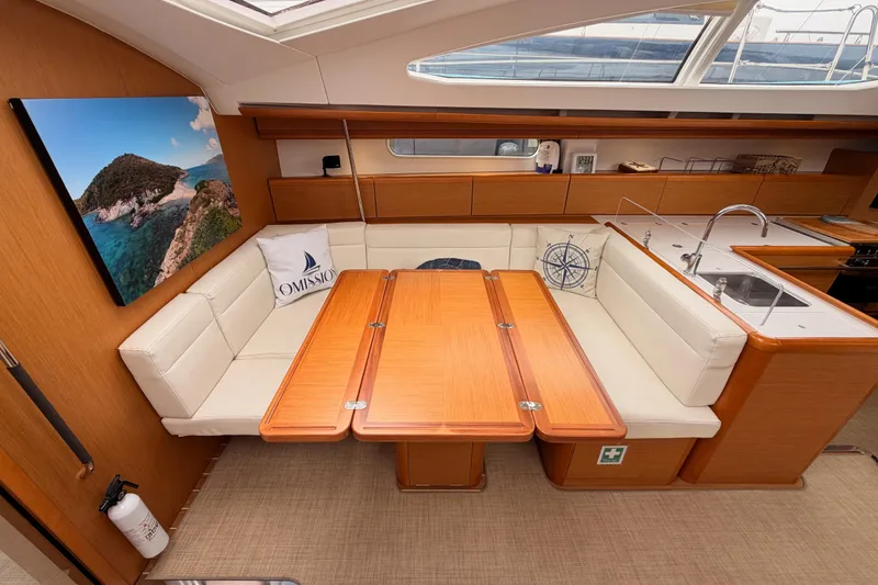 Slide: The Image of Interior of 2014 Jeanneau Sun Odyssey 50 DS yacht with elegant seating and dining area. - 56