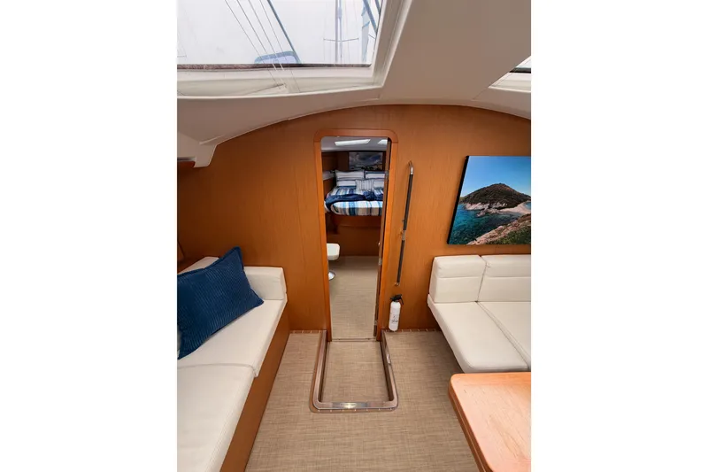 Slide: The Image of Interior of 2014 Jeanneau Sun Odyssey 50 DS yacht, featuring cozy seating and nautical decor. - 58