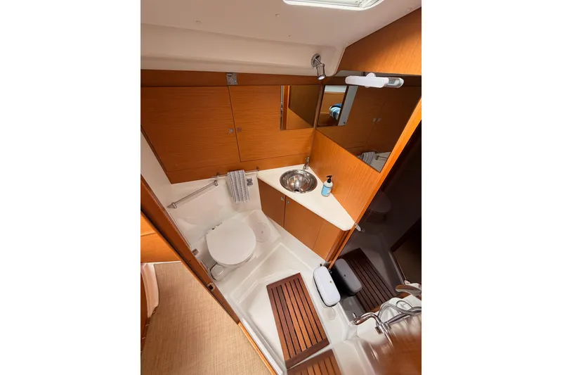 Slide: The Image of Bathroom interior of 2014 Jeanneau Sun Odyssey 50 DS yacht, featuring wooden cabinetry and modern fixtures. - 63