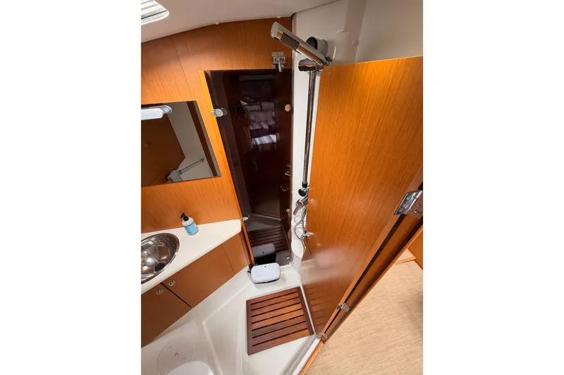 Slide: The Image of Bathroom interior of 2014 Jeanneau Sun Odyssey 50 DS yacht, featuring wooden cabinetry and modern fixtures. - 64