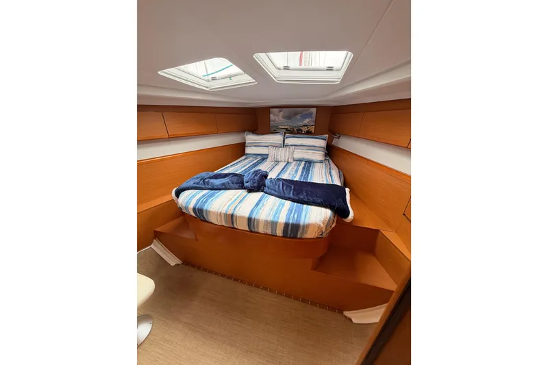 Slide: The Image of Cozy cabin interior of 2014 Jeanneau Sun Odyssey 50 DS with striped bedding. - 66