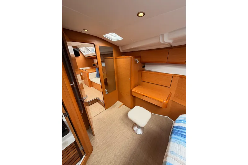 Slide: The Image of Interior of 2014 Jeanneau Sun Odyssey 50 DS yacht, featuring wood finishes and seating area. - 67