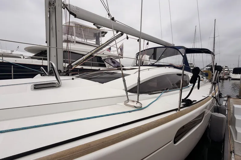 Slide: The Image of 2014 Jeanneau Sun Odyssey 50 DS sailboat docked at marina, side view. - 7