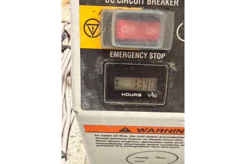 Slide: The Image of Control panel of a 2014 Jeanneau Sun Odyssey 50 DS with emergency stop and hour meter. - 79