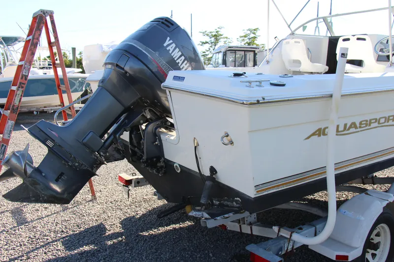 Slide: The Image of 2003 Aquasport 215 Explorer boat with Yamaha outboard motor on a trailer. - 10