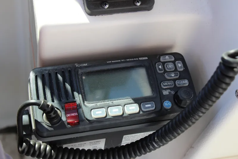 Slide: The Image of VHF marine radio on 2003 Aquasport 215 Explorer boat dashboard. - 7