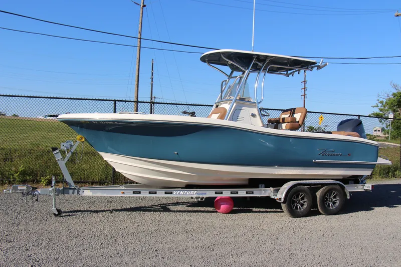 Slide: The Image of 2022 Pioneer 222 Islander boat on trailer, parked outdoors, side view. - 1