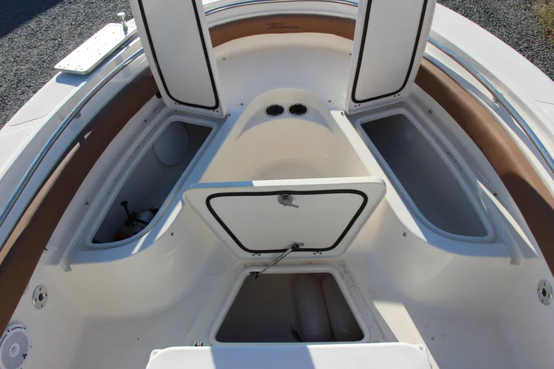 Slide: The Image of 2022 Pioneer 222 Islander boat interior with open storage compartments. - 12