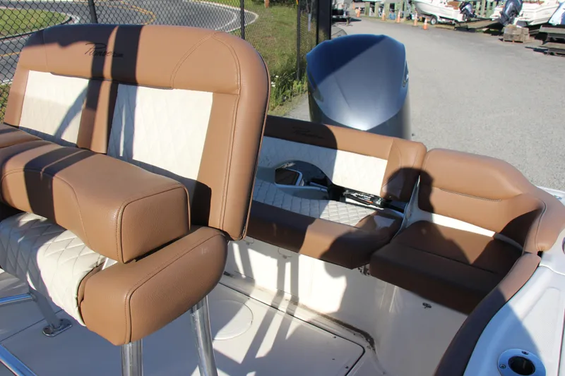 Slide: The Image of 2022 Pioneer 222 Islander boat interior with tan and white cushioned seating. - 7