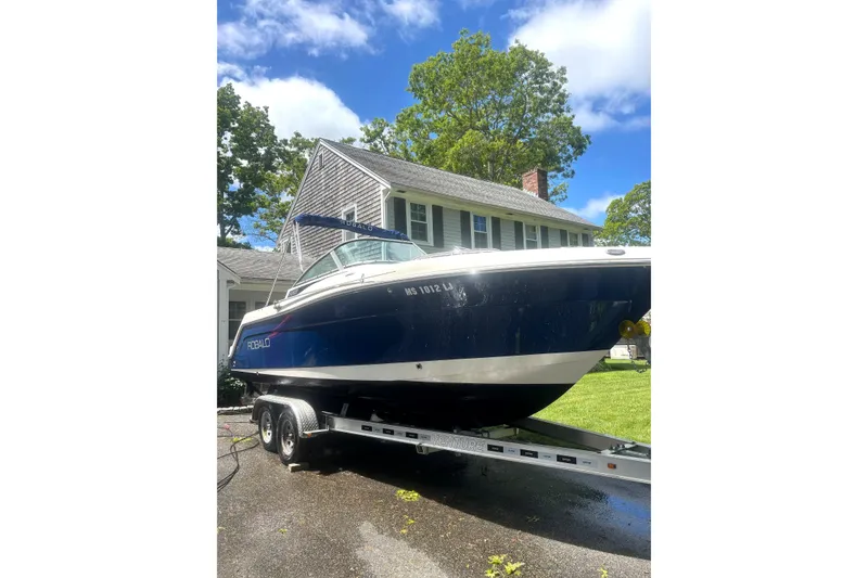 Slide: The Image of 2016 Robalo R227 Dual Console boat on trailer, parked in driveway near house. - 13
