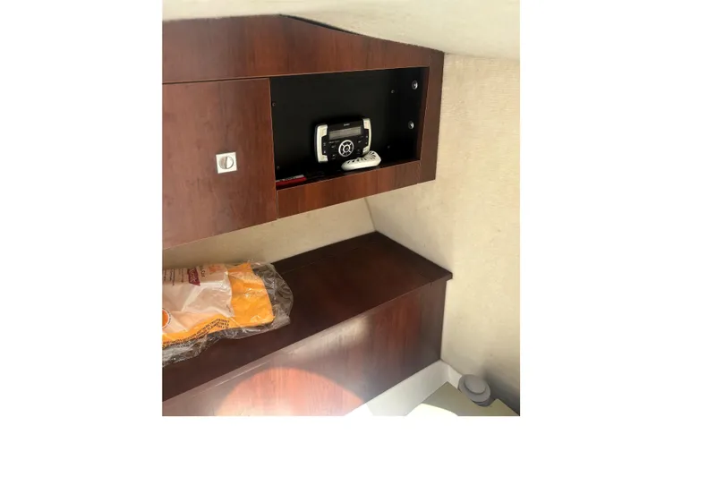Slide: The Image of Interior cabin of 2016 Robalo R227 Dual Console with storage and equipment. - 15