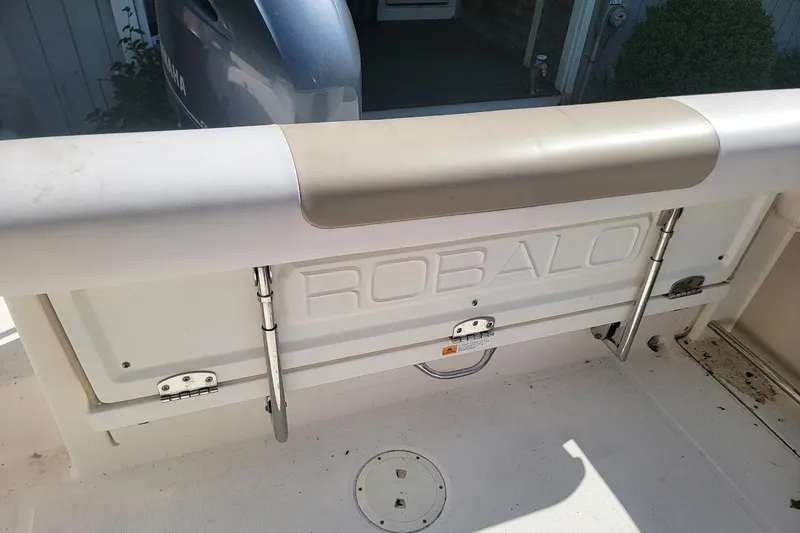 Slide: The Image of 2016 Robalo R227 Dual Console boat interior with visible branding and engine. - 18