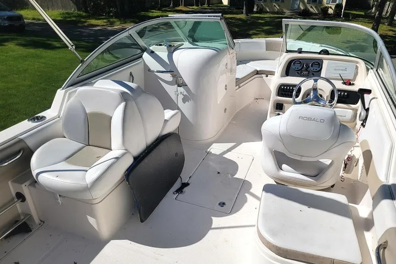 Slide: The Image of 2016 Robalo R227 Dual Console boat interior with white seating and steering console. - 3