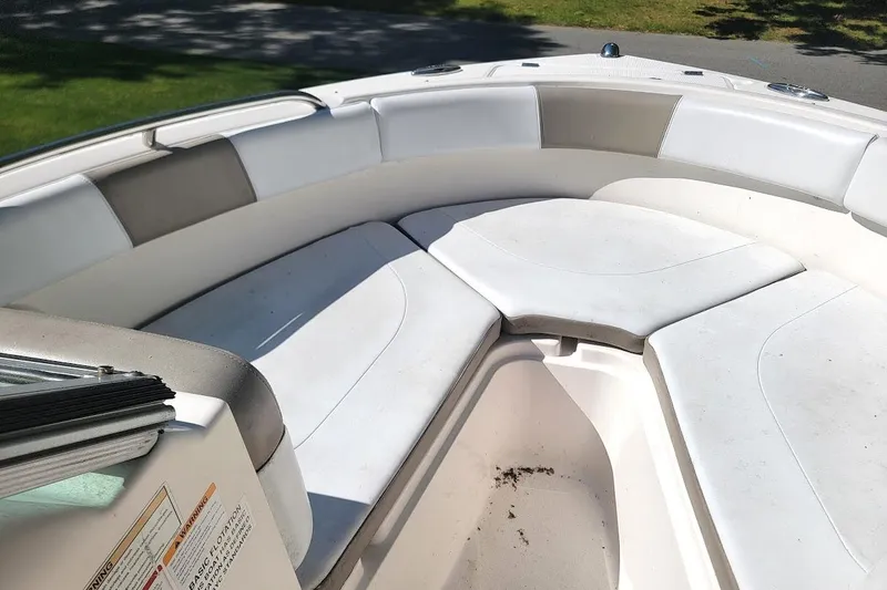 Slide: The Image of 2016 Robalo R227 Dual Console boat interior with white cushioned seating. - 4