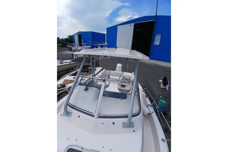 Slide: The Image of 1996 Grady-White Advance 247 boat at marina with blue warehouse background. - 11