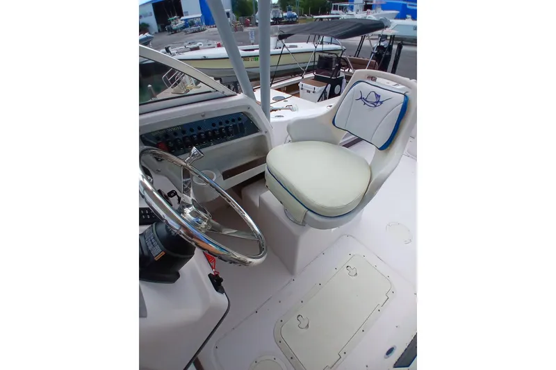 Slide: The Image of Interior view of 1996 Grady-White Advance 247 boat cockpit with steering wheel and captain's chair. - 12