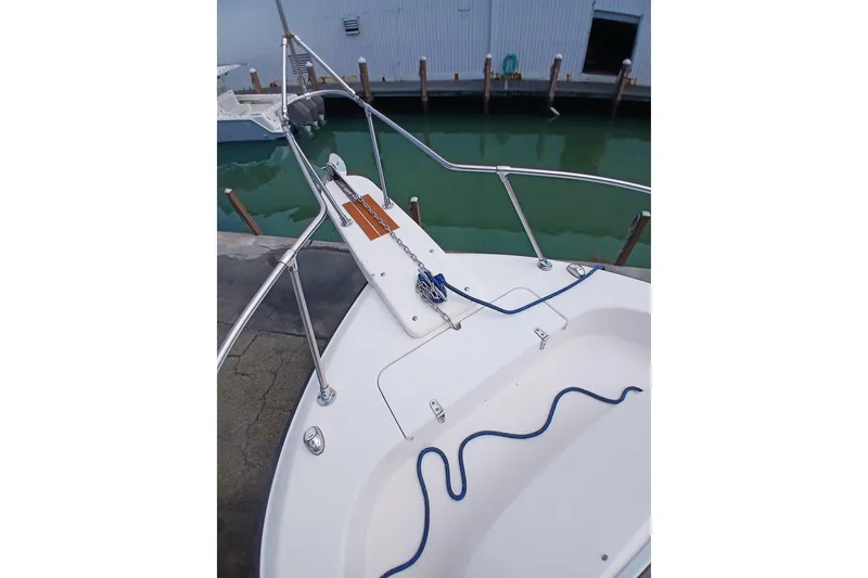 Slide: The Image of Bow view of 1996 Grady-White Advance 247 boat docked by the water. - 13