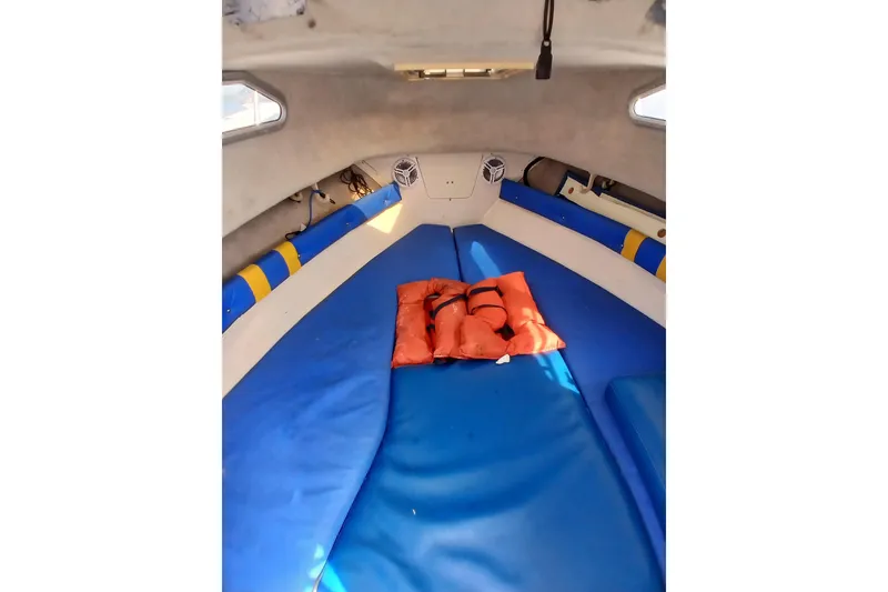 Slide: The Image of Interior of a 1996 Grady-White Advance 247 boat with blue cushions and an orange life jacket. - 17