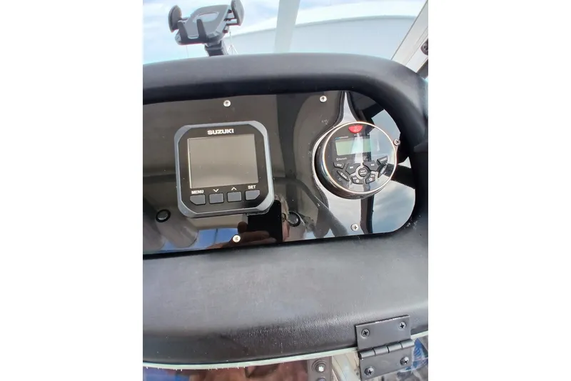 Slide: The Image of Dashboard of a 1996 Grady-White Advance 247 boat with Suzuki controls. - 18