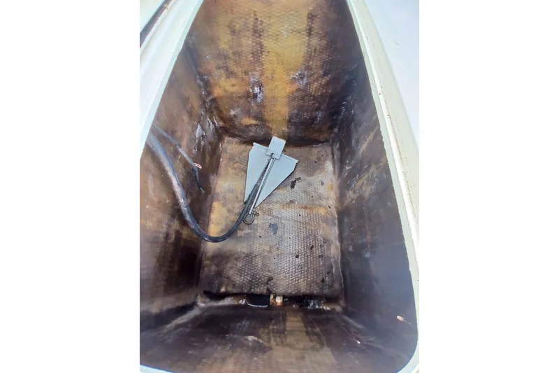 Slide: The Image of Anchor storage compartment of 1996 Grady-White Advance 247 boat, showing anchor and cable. - 19
