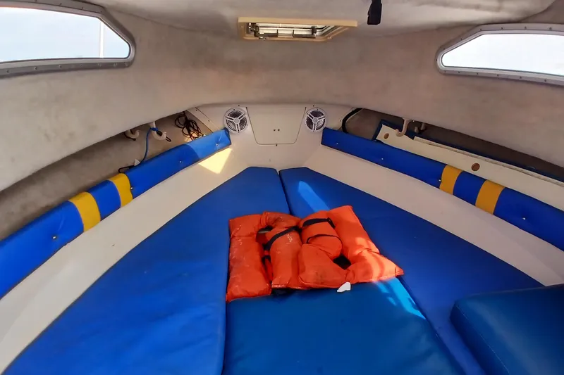 Slide: The Image of Interior cabin of 1996 Grady-White Advance 247 boat with life jackets on blue cushions. - 20