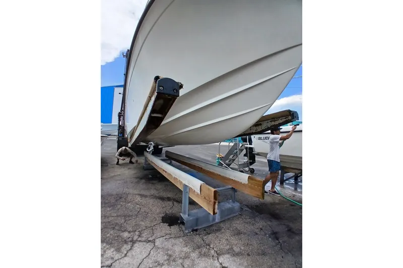 Slide: The Image of 1996 Grady-White Advance 247 boat on trailer, undergoing maintenance at a marina. - 23