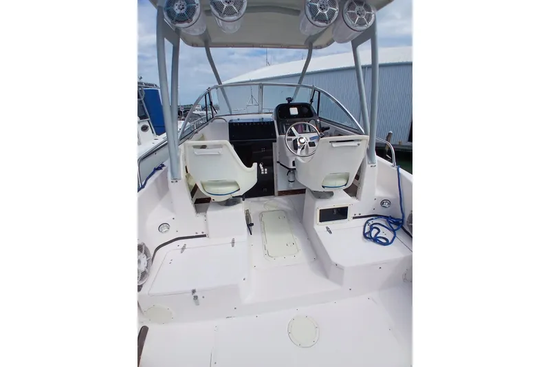 Slide: The Image of 1996 Grady-White Advance 247 boat interior with steering wheel and seating. - 29