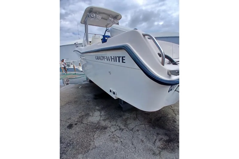 Slide: The Image of 1996 Grady-White Advance 247 boat on dry dock, showcasing sleek design and branding. - 32